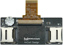 Load image into Gallery viewer, Black electronic circuit board component with dual white connectors and gold flex ribbon connector, branded MCM Concepts imCort Design.
